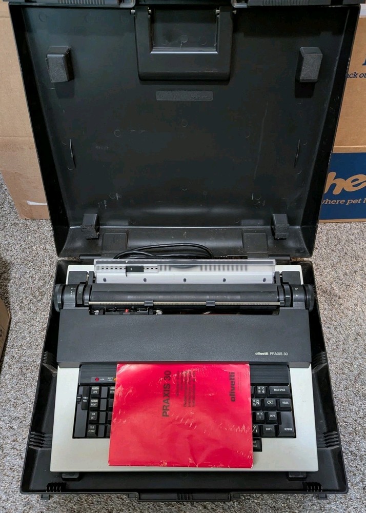 olivetti “Praxis 30” Travel Electronic Typewriter – Case, Cord, and Manual.